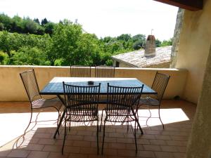 a table and chairs sitting on a patio at Maison Jules Goux in Mirmande