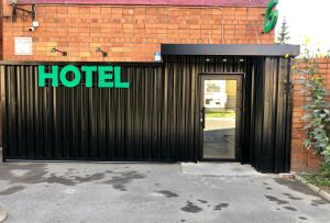 a hotel sign on the side of a brick building at Greenfeel Hotel Pskov in Pskov