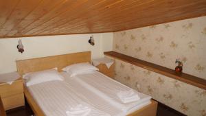 a bedroom with a large bed in a room at Pensiunea Medieval in Predeal +57 photos
