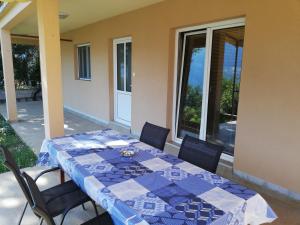 a blue and white table and chairs on a patio at Ruža Apartments Sea View in Kotor