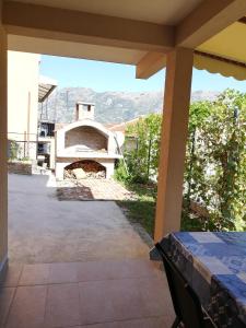 a view from the porch of a house with a pizza oven at Ruža Apartments in Kotor