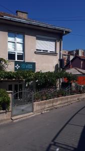 a building with a sign on the side of a street at Edelweiss Hostel in Štip