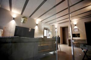 a living room with a couch and a television at Casa Nostra Boutique Hotel & Spa in Palermo