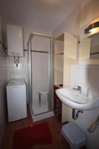 a bathroom with a sink and a shower at Ferienpark An der Seebrücke in Ostseebad Koserow +34 photos