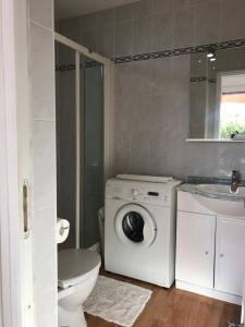 a bathroom with a washing machine and a sink at LOFT 360° Nice in Nice