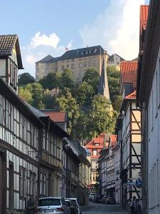 a city street with buildings and cars on a hill at FeWo 13 „Blankenburger Löwe“ in Blankenburg