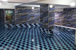 a bathroom with a black and white checkered floor at Business Grand Hotel in Ankara