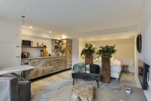 a living room with a chair and a table at Luxury Beach Studio Zandvoort in Zandvoort