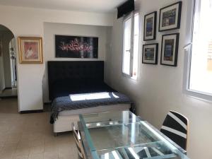 a living room with a couch and a glass table at VOILES ST TROPEZ APARTEMENTS in Saint-Tropez