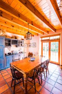 a large kitchen with a wooden table and chairs at Die Wasbak in Greyton