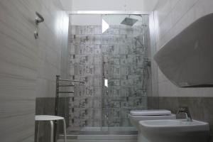 a bathroom with a shower and a toilet and a sink at B&B A casa di Emy in Barisciano