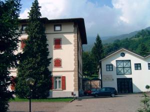 a house with a car parked in front of it at Hotel Villa Flora in Roncegno