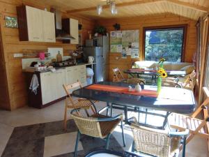 a kitchen and dining room with a table and chairs at Homestay Srebrny Potok in Zakopane