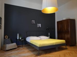 a bedroom with a bed with a black wall at Luxury Old Town Apartment Pula in Pula