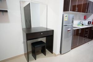a small kitchen with a counter and a refrigerator at Aurak Guest House in Ras al Khaimah
