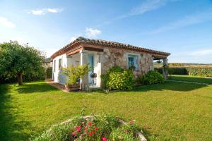 una pequeña casa en un campo con un patio en Casa Vacanze Diaz, en Budoni