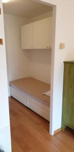 a small bedroom with a bed and cabinets at Studio au pied des pistes Briançon Serre Chevalier in Briançon