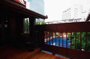 a view of a pool from the balcony of a building at Rose Hotel in Bangkok