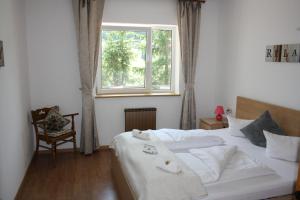 1 dormitorio con 2 camas blancas y ventana en Wiesenhof, en Berwang