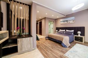 a bedroom with a king sized bed and a television at Hotel Princess & Spa in Ulcinj