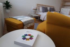 a room with a table with a book on it at Hniezdo v Raji 1 - Luxurious apartment 3 min walk to city center in Spišská Nová Ves