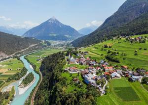 a village in a valley with a river and mountains at Gasthof Venetrast in Imsterberg
