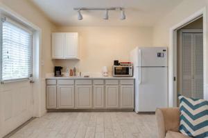a kitchen with a white refrigerator and a couch at Blue Sage in Siesta Key