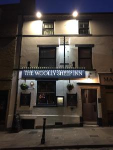 a building with a sign on the side of it at The Woolly Sheep Inn in Skipton