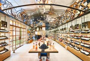 a large room with shelves of wine bottles at Château de la Gaude in Aix-en-Provence