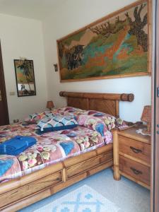 a bedroom with a bed and a map on the wall at B&B Zia Delia in Villaperuccio