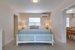 a bedroom with a large bed with two lamps at Elderberry in Siesta Key