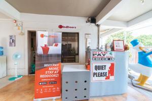 a room with a store with a sign and a room with a toy duck at RedDoorz @ Aparente Gensan in General Santos
