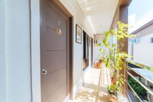 a hallway of a house with a door and a plant at RedDoorz @ Aparente Gensan in General Santos