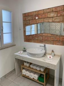 a bathroom with a sink and a mirror at Alter Village Apartments in Alter do Chão +29 photos