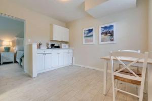 a kitchen with a table and a dining room at Whitewood in Siesta Key