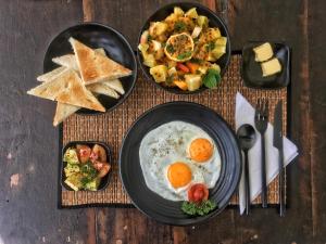 a table with two plates of food with eggs and toast at Lighthouse Ahangama in Ahangama