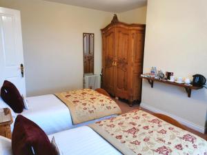 
a bedroom with a bed and a desk at Northumberland Cottage B&B in Eshott

