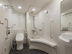 a bathroom with a toilet and a sink and a shower at APA Hotel & Resort Yokohama Bay Tower in Yokohama