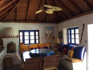 a living room with a ceiling fan and a table at La Casa de las Higueras Dar Karmus Tetouan in Tetouan