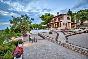 a house with a stone walkway in front of it at Villa Agapi in Athanion