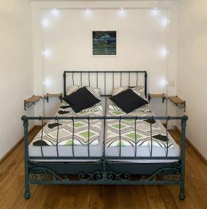 a bedroom with a metal bed with pillows at Ferienwohnung Drachennest mit Sonnenterrasse in Feldkirch