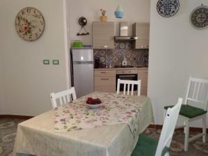 una cucina con tavolo e ciotola di frutta di Una Scala Dal Centro a Agrigento