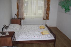 a bedroom with a bed with two towels on it at Apartmán v Kašperských Horách in Kašperské Hory