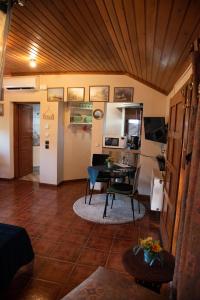 a living room with a table and a dining room at COZY LOFT (studio) 360o VIEW OF ATHENS in Athens