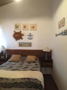 a bedroom with a bed and two nightstands and acknowled at Praia do Forte Apartamento Fantástico in Praia do Forte