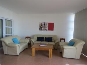 a living room with two couches and a coffee table at Vista Bonita Apartments in Mossel Bay