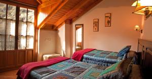 a bedroom with two beds and a window at Apartamentos Valdecarzana Senda del Oso in San Martín