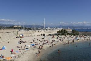 un groupe de personnes sur une plage près de l'eau dans l'établissement L OLIVIER, à Antibes