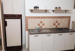 a kitchen with a sink and a stove at Liberty House in Marsala