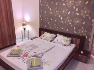 a bedroom with a bed with a flower pattern on the wall at Kabakum Holiday Apartment in Varna City